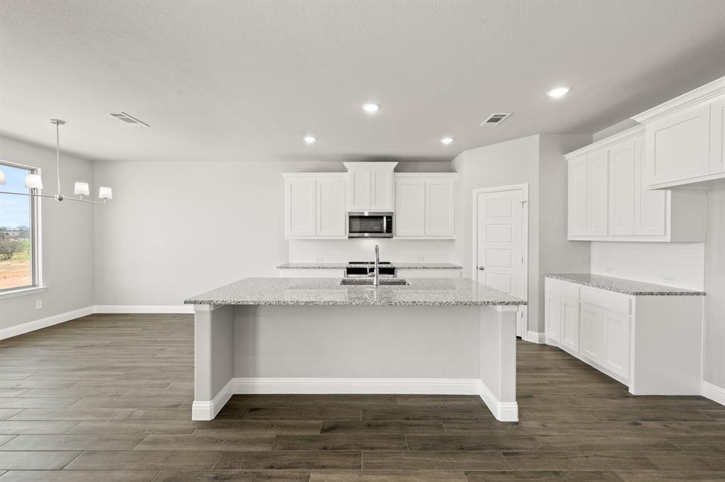 7016 Ranch View Place Springtown, TX 76082 - Photo 5 of 29 a view of a kitchen with center island and wooden floor