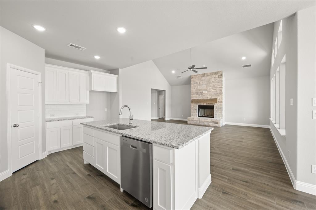 7016 Ranch View Place Springtown, TX 76082 - Photo 8 of 29 a kitchen with a sink stove and cabinets