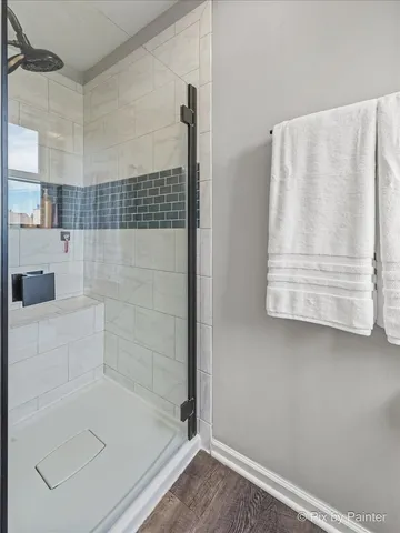 a spacious bathroom with a sink a large mirror and a shower