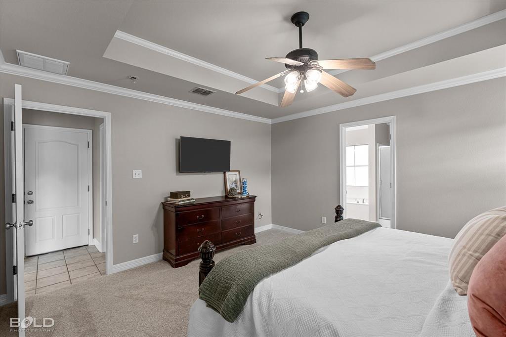 116 Augusta Avenue Benton, LA 71006 - Photo 22 of 38 a bedroom with a bed and a flat tv screen on the dresser