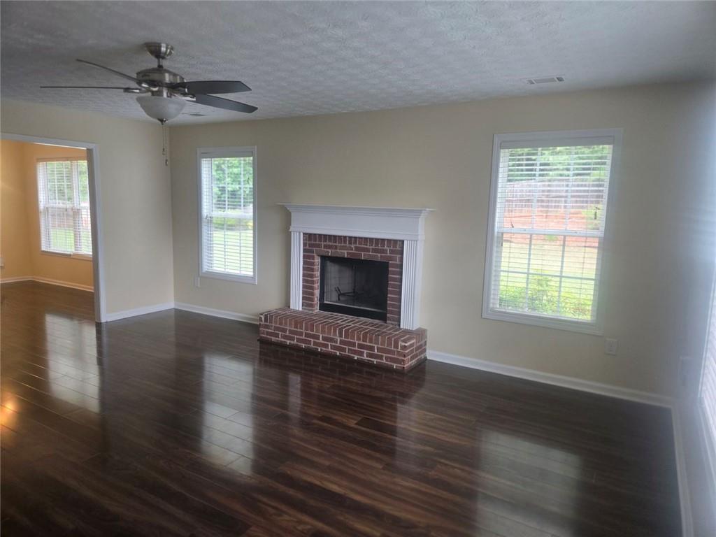 22 Windcrest Keep Covington, GA 30016 - Photo 5 of 32 a view of an empty room with a window and wooden floor
