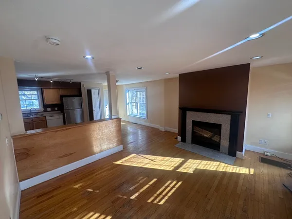 a view of a living room with a fireplace