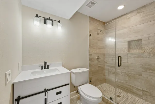 a bathroom with a sink mirror toilet and shower