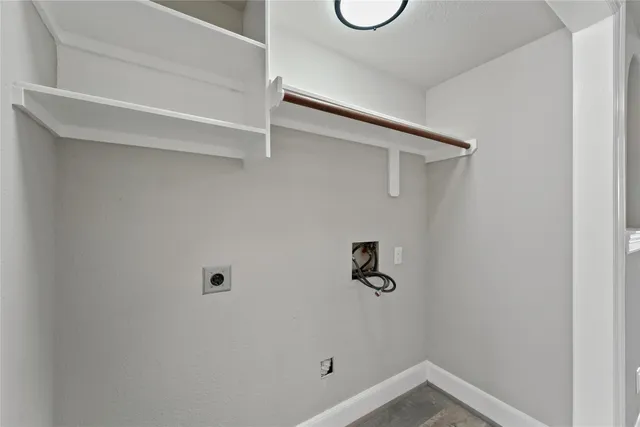 an empty room with windows chandelier fan and windows