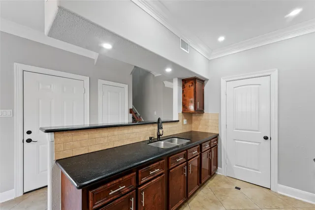a kitchen with a sink and cabinets