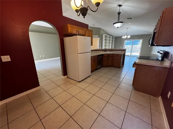 a kitchen with stainless steel appliances a refrigerator sink and microwave