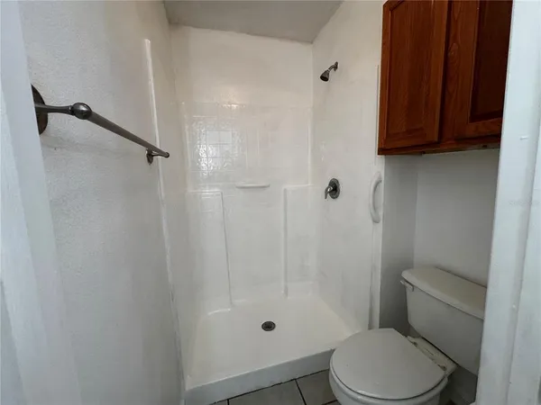 a bathroom with a shower a toilet and a sink