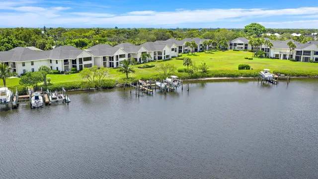 an aerial view of a house with outdoor space lake view and mountain view