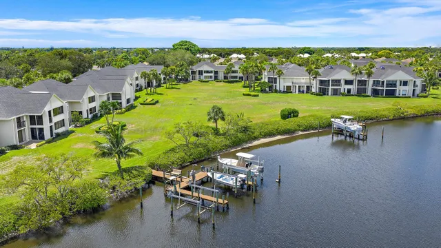 a view of a lake with lawn chairs
