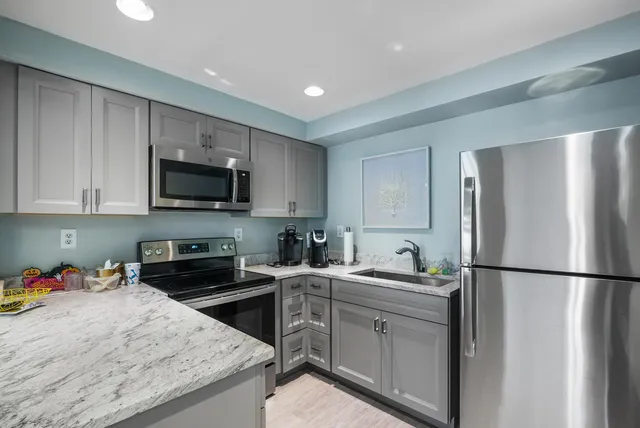 a view of a patio with table and chairs and potted plants