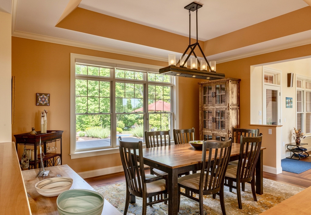 1089 Westhampton Road Northampton, MA 01062 - Photo 12 of 42 a dining room with furniture a chandelier and wooden floor