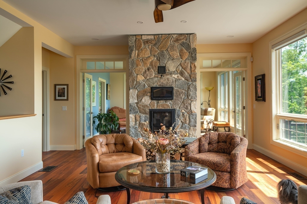 1089 Westhampton Road Northampton, MA 01062 - Photo 14 of 42 a living room with furniture a fireplace and a large window