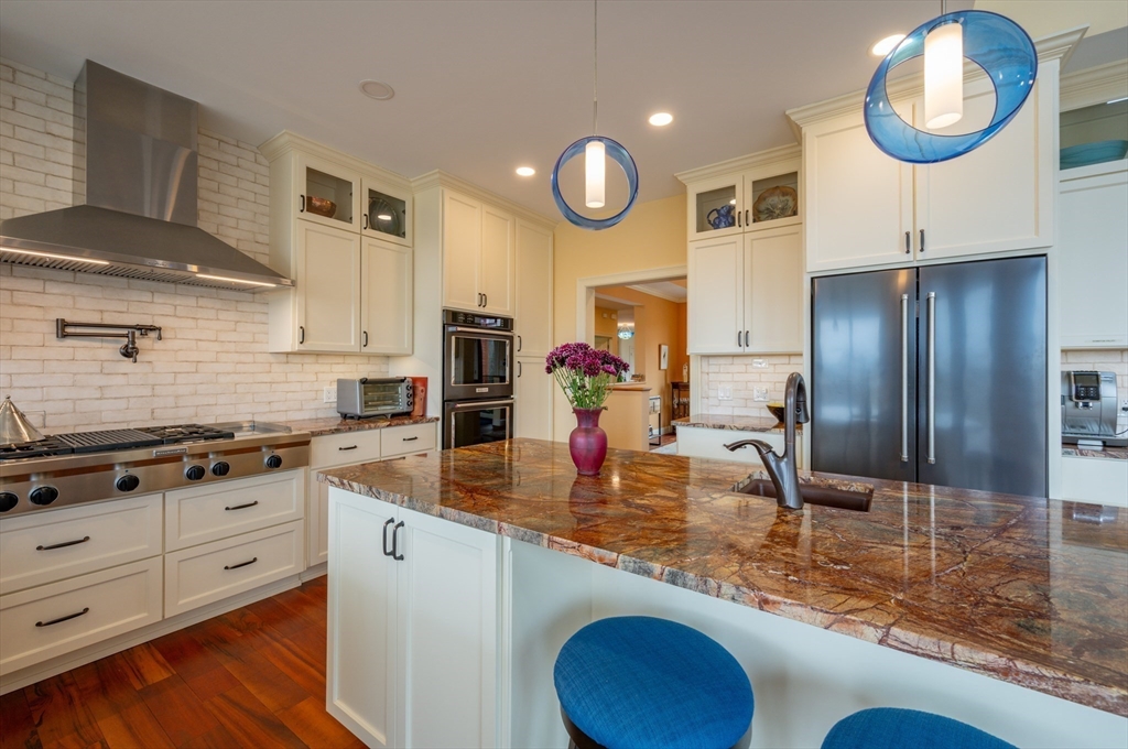 1089 Westhampton Road Northampton, MA 01062 - Photo 19 of 42 a kitchen with stainless steel appliances granite countertop a sink a stove and a refrigerator