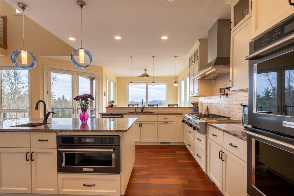 1089 Westhampton Road Northampton, MA 01062 - Photo 20 of 42 a kitchen with stainless steel appliances granite countertop a stove and a sink