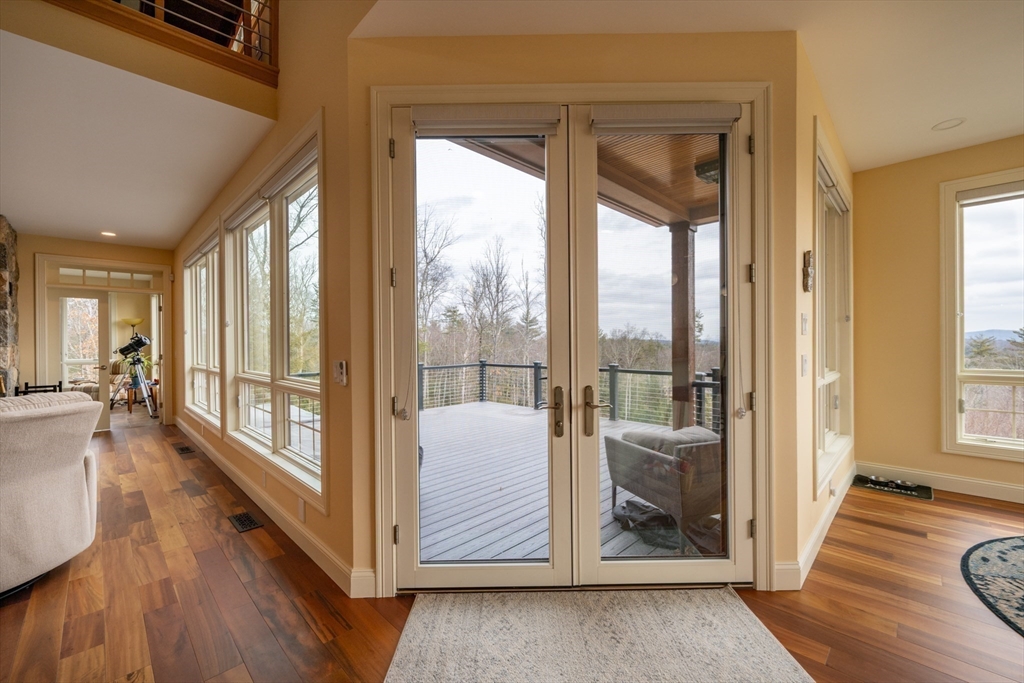 1089 Westhampton Road Northampton, MA 01062 - Photo 23 of 42 a living room with wooden floor and a large window