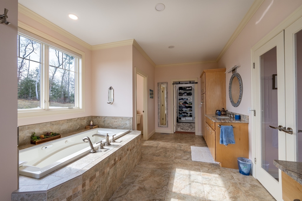 1089 Westhampton Road Northampton, MA 01062 - Photo 32 of 42 a bathroom with a tub sink and mirror