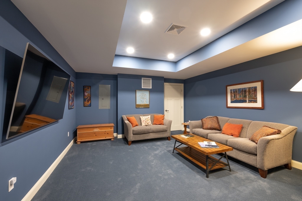 1089 Westhampton Road Northampton, MA 01062 - Photo 35 of 42 a living room with furniture and a flat screen tv