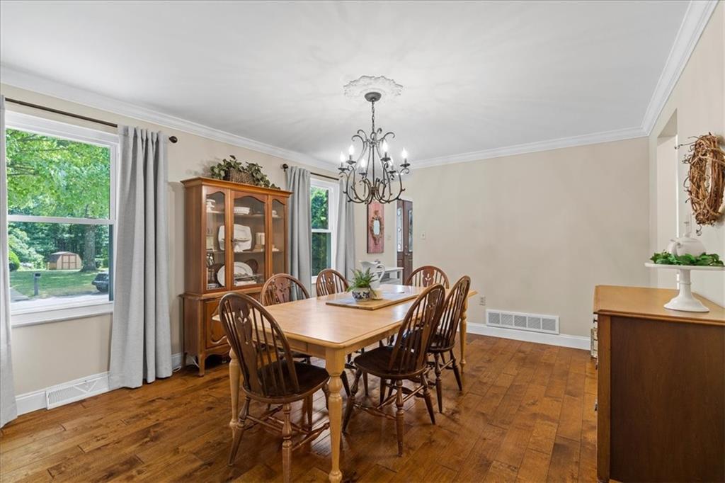 115 Windmill Road Butler, PA 16002 - Photo 12 of 36 a dining room with furniture a chandelier and wooden floor