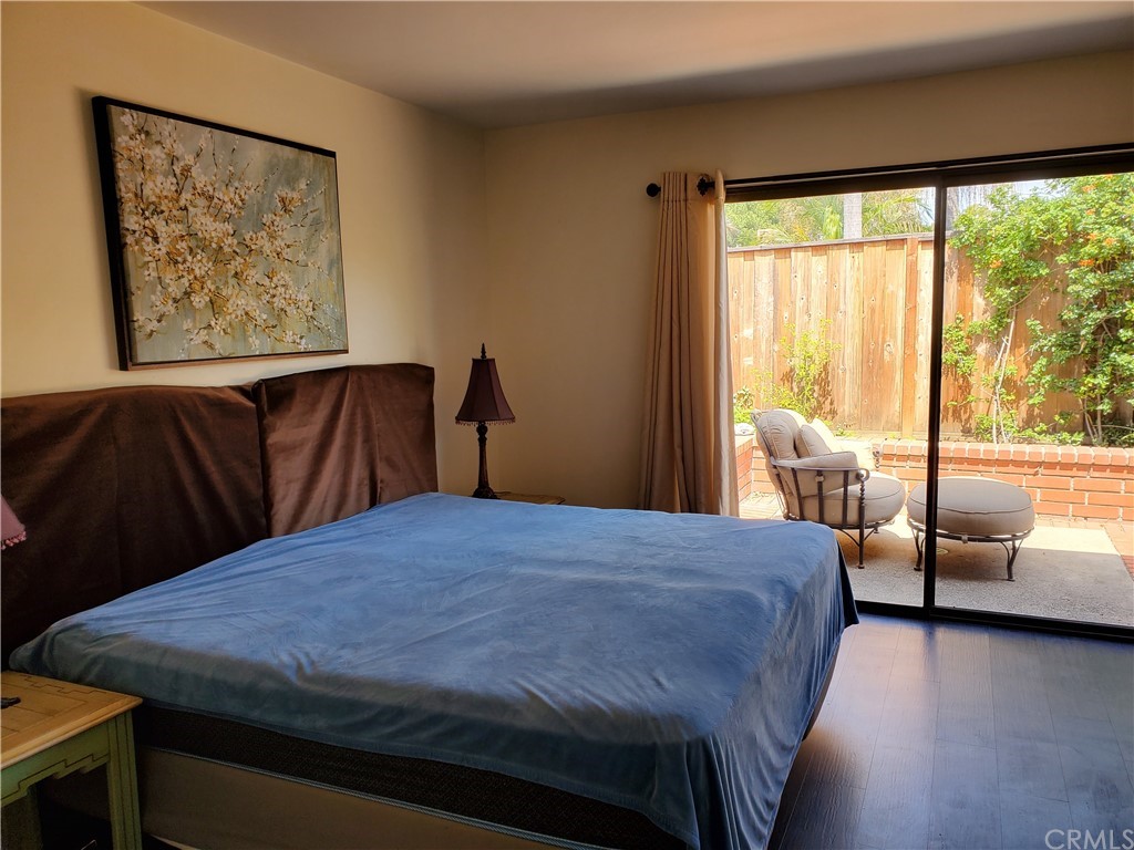 5001 Paseo Dali Irvine, CA 92603 - Photo 13 of 20 a bedroom with a bed and wooden floor