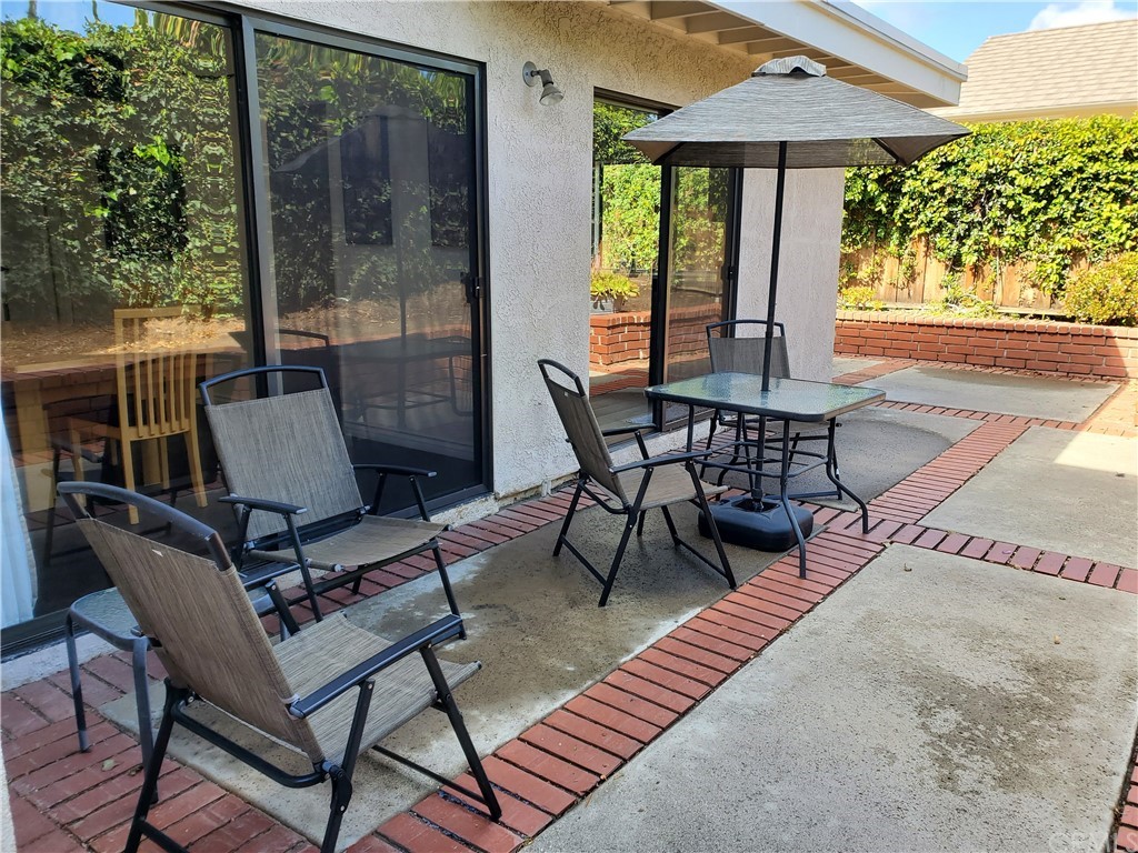 5001 Paseo Dali Irvine, CA 92603 - Photo 3 of 20 a view of a patio with a table chairs and backyard