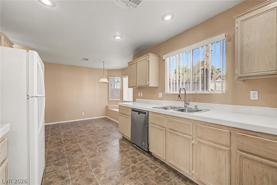 2223 Ramsgate Drive Henderson, NV 89074 - Photo 10 of 32 Well-lit kitchen with generous counter space, abundant cabinetry, and a dedicated dining nook.