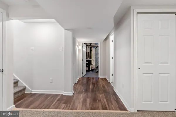 a view of hallway with wooden floor