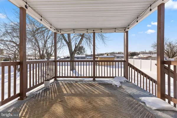 a view of a porch with wooden floor