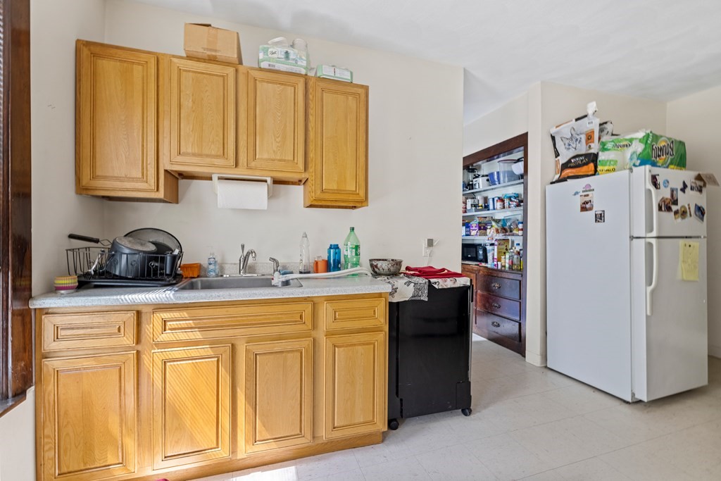 382 McGrath Highway Somerville, MA 02143 - Photo 16 of 31 a kitchen with stainless steel appliances granite countertop a refrigerator and a stove