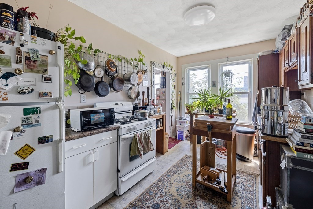 382 McGrath Highway Somerville, MA 02143 - Photo 21 of 31 a kitchen with cabinets and a stove