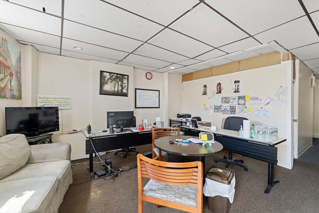 382 McGrath Highway Somerville, MA 02143 - Photo 23 of 31 a work room with furniture and a flat screen tv