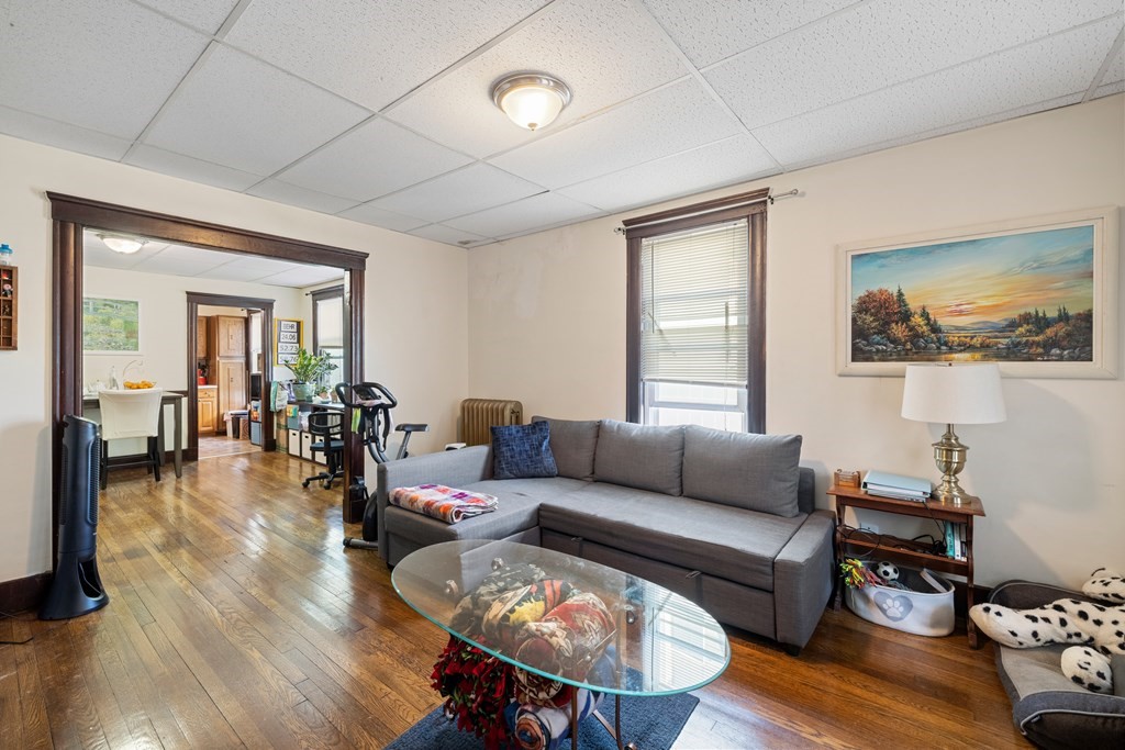 382 McGrath Highway Somerville, MA 02143 - Photo 5 of 31 a living room with furniture and a wooden floor