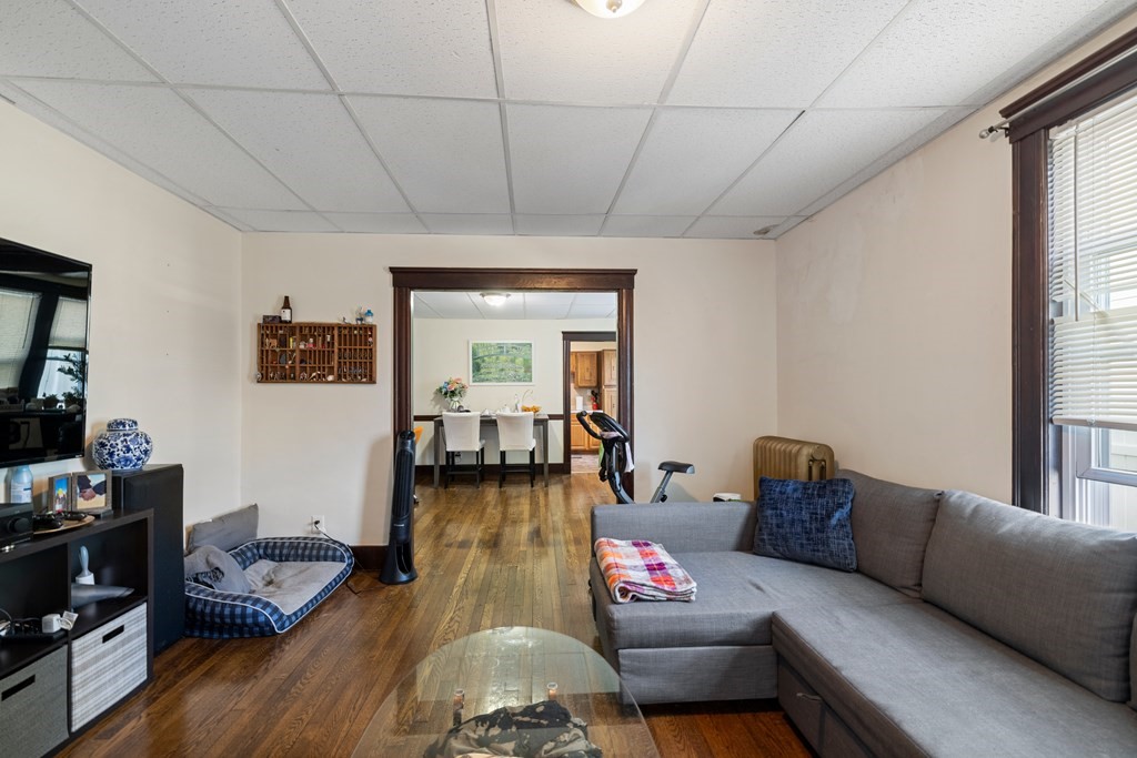 382 McGrath Highway Somerville, MA 02143 - Photo 6 of 31 a living room with furniture and wooden floor
