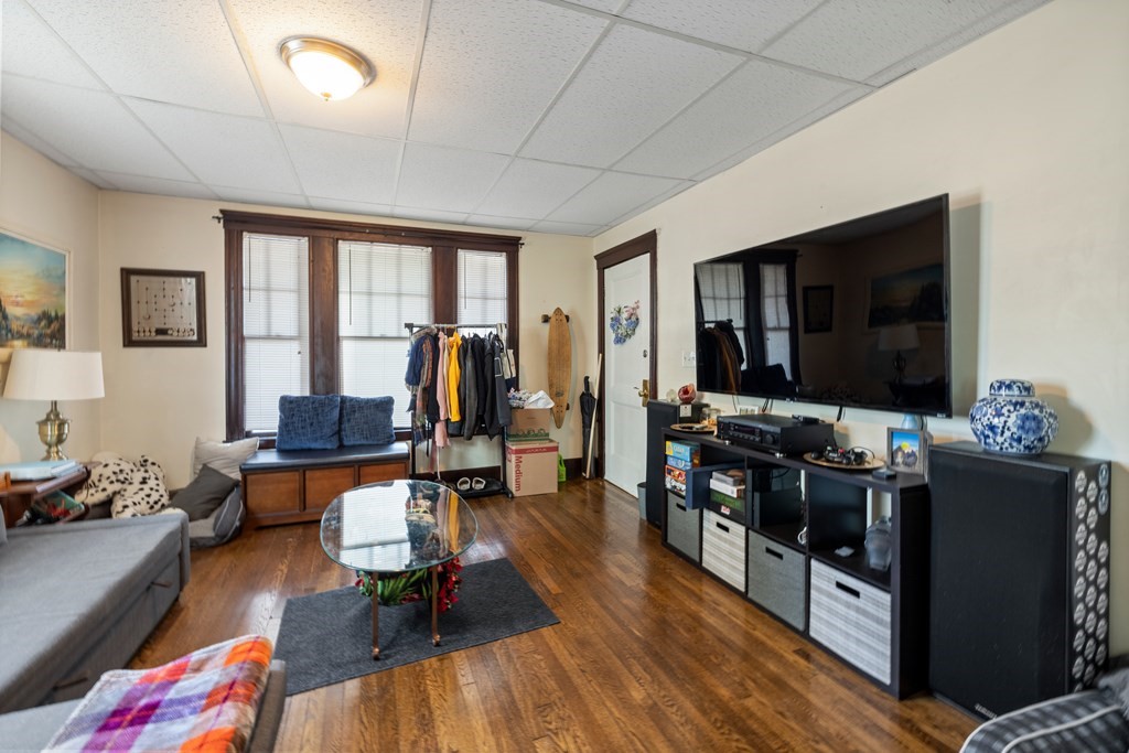 382 McGrath Highway Somerville, MA 02143 - Photo 7 of 31 a living room with furniture and a flat screen tv