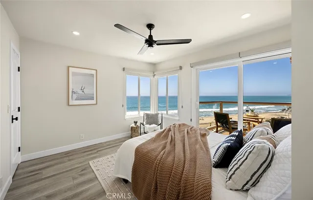 a bedroom with furniture and large windows