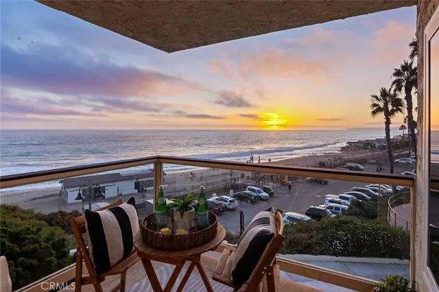 a view of a large building with a lot of cars on the road