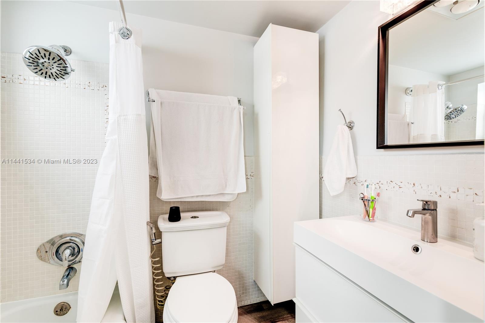 200 Northeast 12th Avenue, Unit 5B Hallandale Beach, FL 33009 - Photo 12 of 26 a bathroom with a sink a toilet and mirror