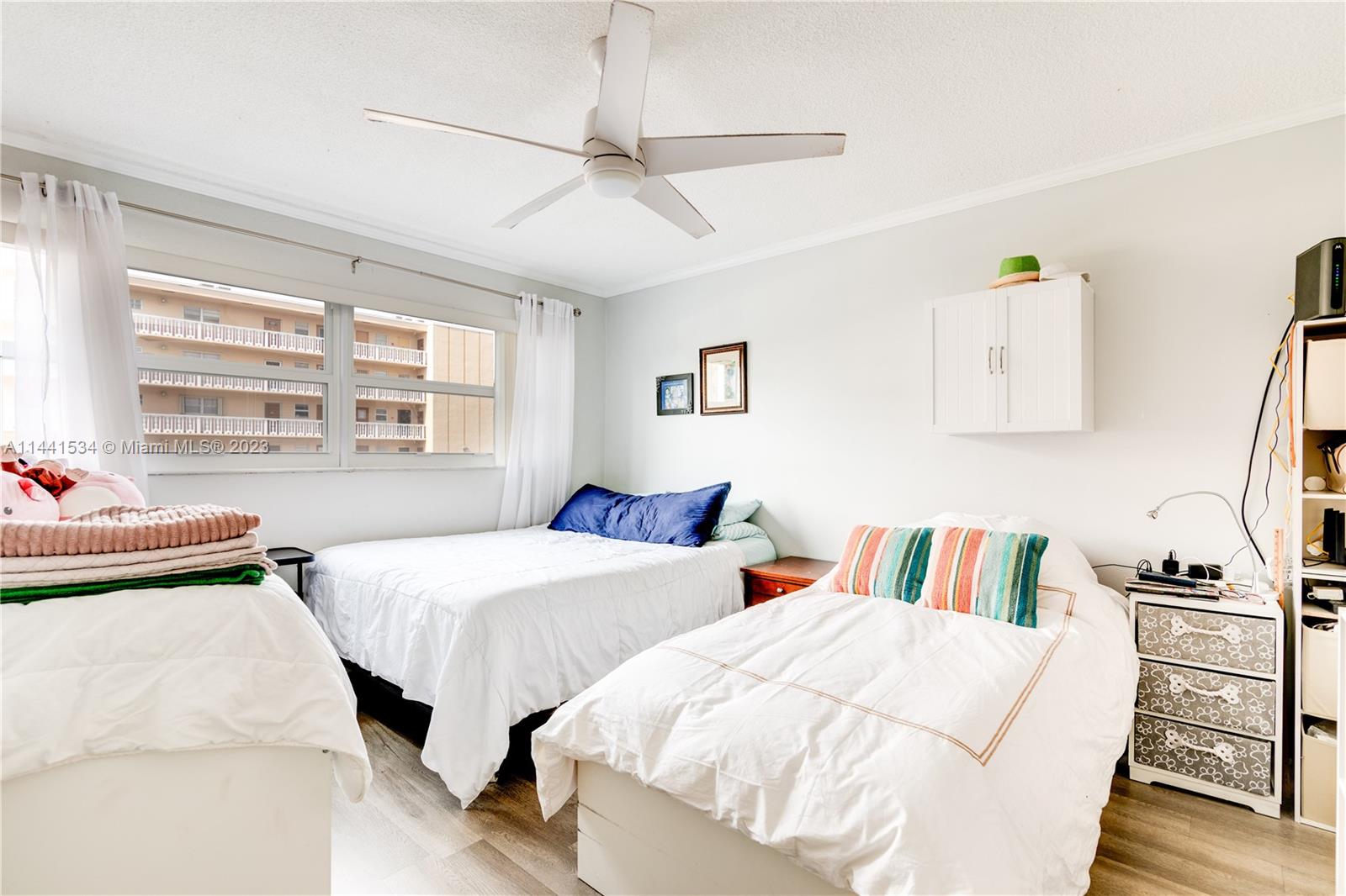 200 Northeast 12th Avenue, Unit 5B Hallandale Beach, FL 33009 - Photo 13 of 26 a bedroom with two beds and a window