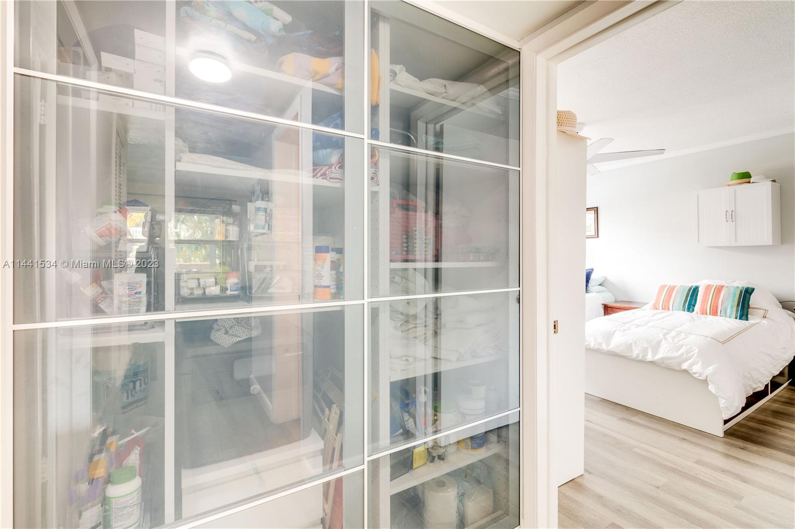 200 Northeast 12th Avenue, Unit 5B Hallandale Beach, FL 33009 - Photo 14 of 26 a living room with a bed and glass door