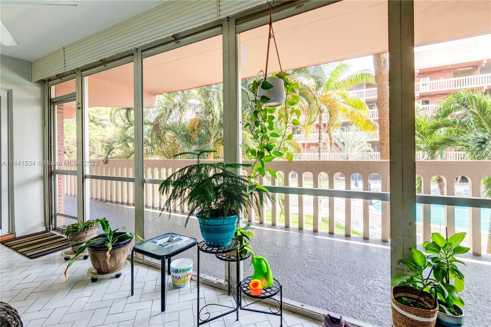 200 Northeast 12th Avenue, Unit 5B Hallandale Beach, FL 33009 - Photo 17 of 26 a living room filled with furniture and a potted plant