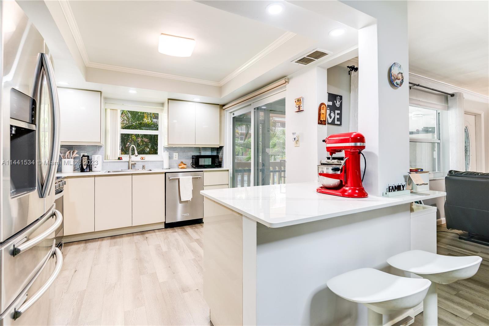 200 Northeast 12th Avenue, Unit 5B Hallandale Beach, FL 33009 - Photo 2 of 26 a kitchen with a sink a stove and chairs