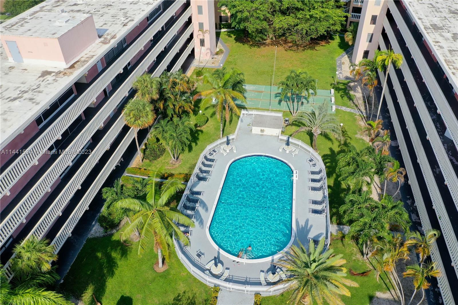200 Northeast 12th Avenue, Unit 5B Hallandale Beach, FL 33009 - Photo 25 of 26 a view of a swimming pool with a backyard