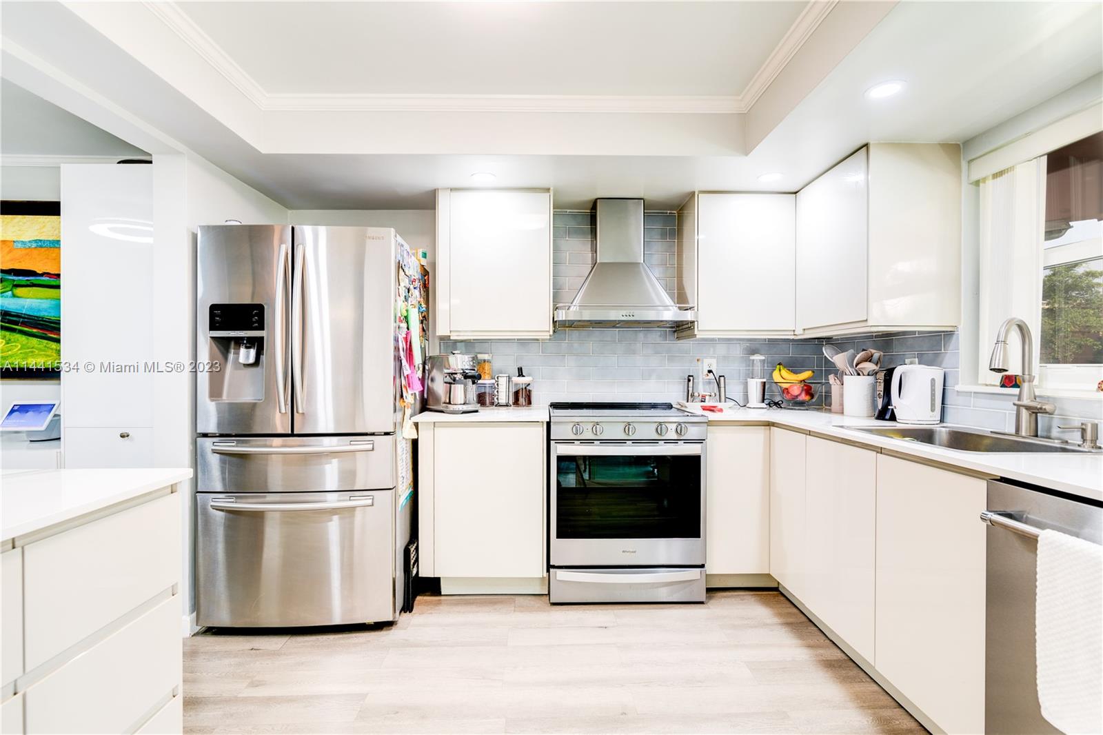 200 Northeast 12th Avenue, Unit 5B Hallandale Beach, FL 33009 - Photo 3 of 26 a kitchen with stainless steel appliances a refrigerator sink and microwave