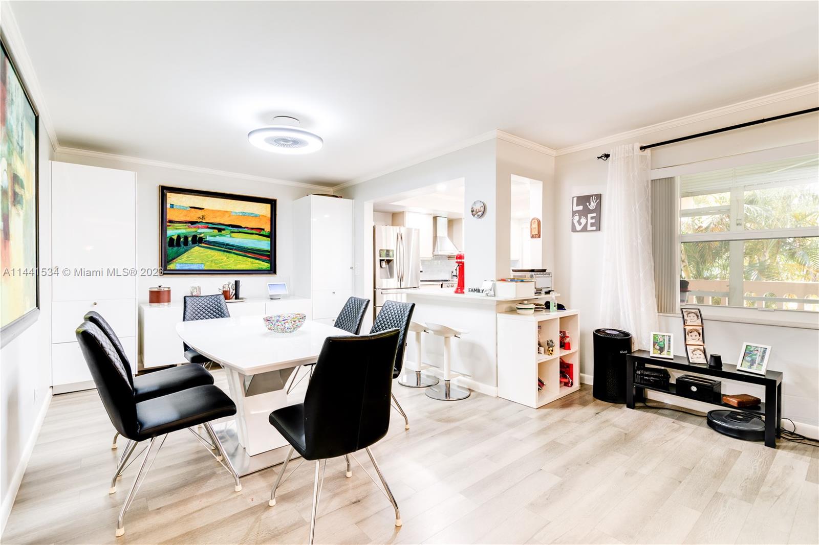 200 Northeast 12th Avenue, Unit 5B Hallandale Beach, FL 33009 - Photo 7 of 26 a living room with furniture and a flat screen tv