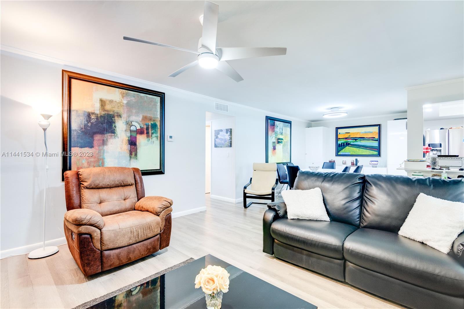 200 Northeast 12th Avenue, Unit 5B Hallandale Beach, FL 33009 - Photo 10 of 26 a living room with furniture and a painting