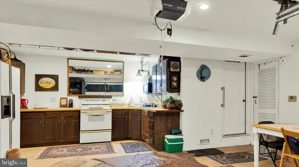 a kitchen with stainless steel appliances granite countertop a refrigerator a sink a stove and a wooden cabinets