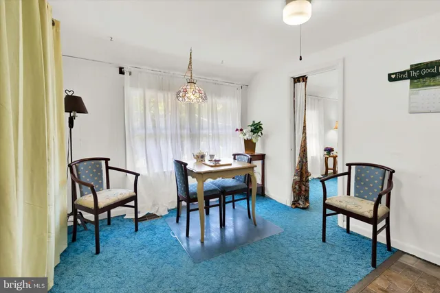 a living room with furniture and large windows