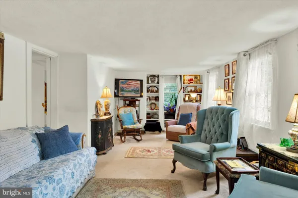 a living room with furniture a flat screen tv and a dining table