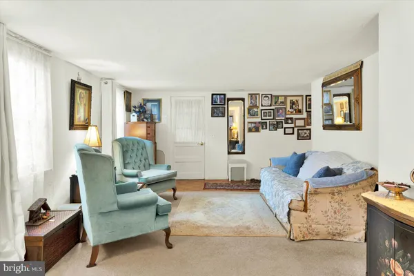 a living room with furniture large window and a flat screen tv