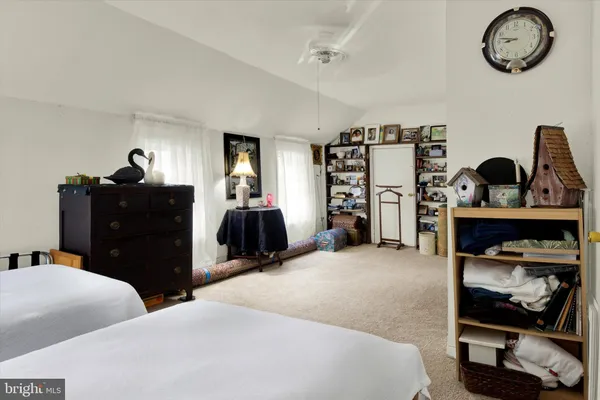 a living room with furniture and a mirror