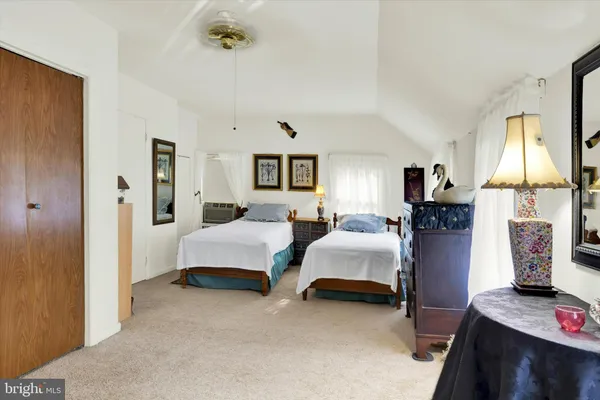 a bedroom with furniture and a window